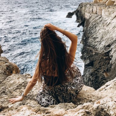 arkadan görünüşü rocky Dağları üstünde tepe-in rahatlatıcı sahil karanlık su ile elbiseli genç erkek rüzgarlı gün
