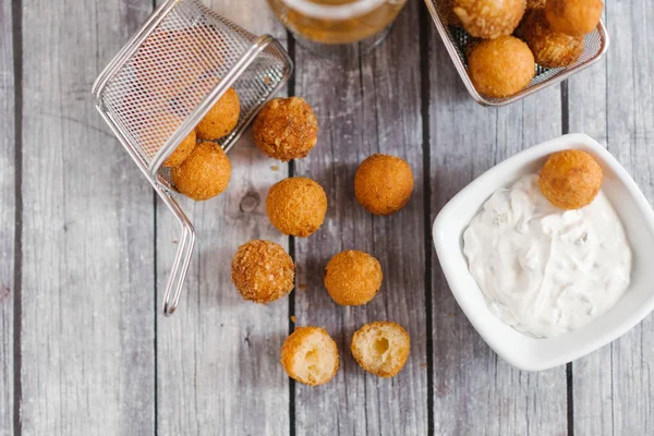 top view of homemade cheese balls with sauce on grey wooden table background