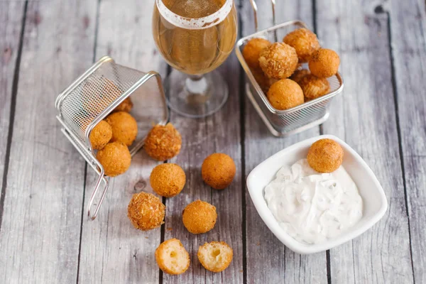 top view of homemade cheese balls with beer on wooden table background