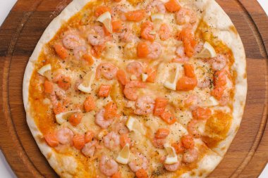 Pizza domates sosu, peynir, karides, somon ve limon adet ahşap pizza tabakta Görünümü Kapat 