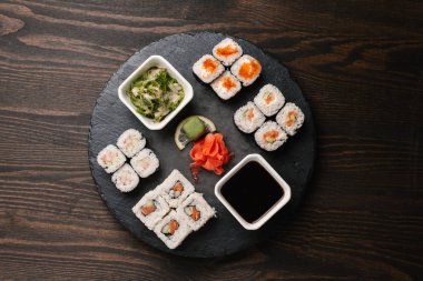Karanlık taş Marine zencefil, wasabi, yosunlar ve soya sosu ile tabakta maki sushi farklı türde Üstten Görünüm