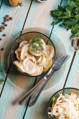 Et köfte closeup cam tabak üzerinde mavi ahşap masa üzerinde çatal ve lahana salatası ile servis