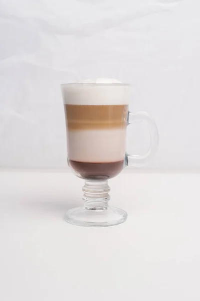 Closeup of irish coffee served in glass isolated on white background