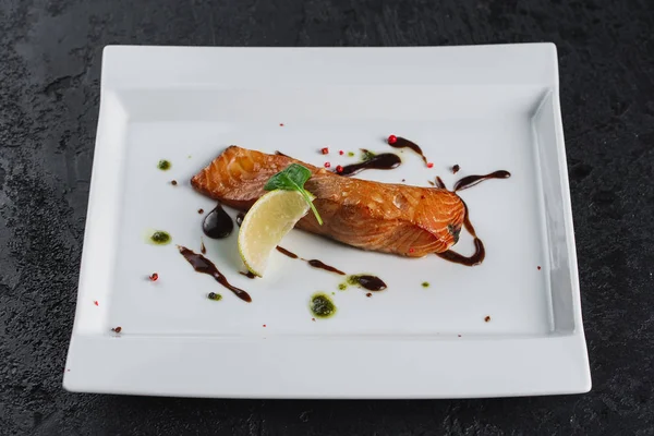 salmon with sauce on white plate