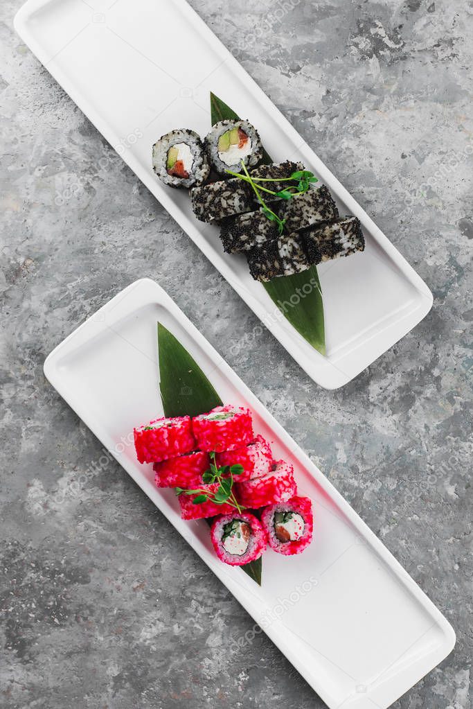 tasty sushi rolls on white plates, Japanese food