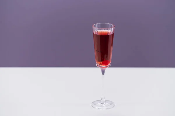 glass with red wine on dark background