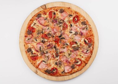 Pizza with tomato sauce, salami, bacon and mushrooms served on wooden plate