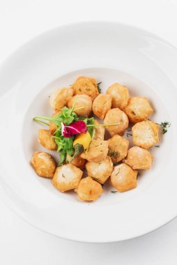 Top view of fried meat dumplings with peppers on white plate