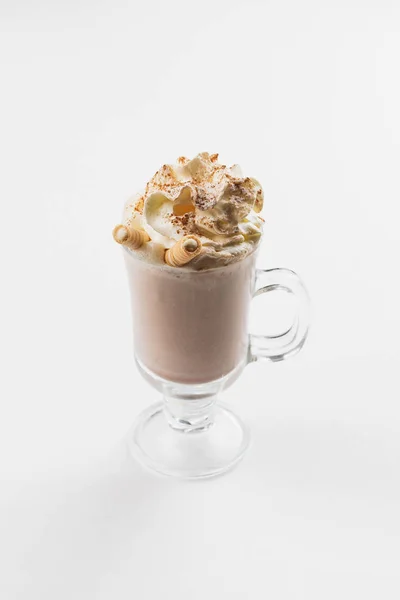 cup of cocoa with cream and crispy tubules on the table