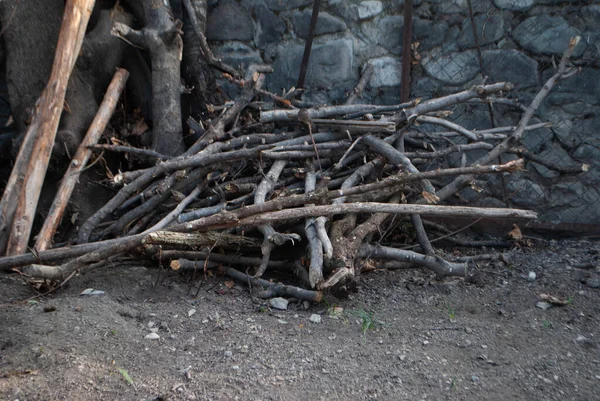 A pile of wooden sticks in the backyard. Wooden sticks. Pile of woods. Woods for a fireplace