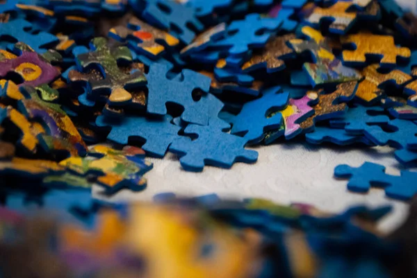 Close-up of colorful pieces of puzzle. Stack of Puzzle Pieces. Puzzle pieces. Puzzle figures. Puzzle for fun.