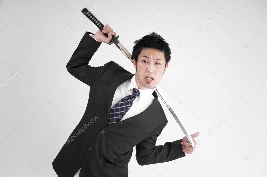 Asian man with japanese sword katana isolated on white background 