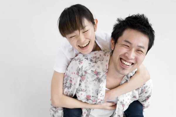 Man giving piggyback ride to woman