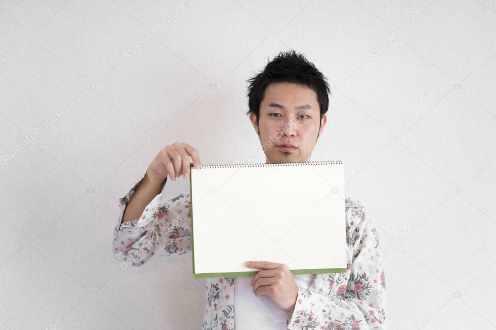 Asian businessman holding blank paper sheet