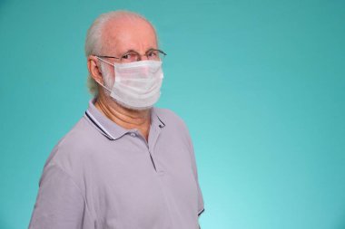 Sağlık hizmetleri için ilaç maskesi kullanan yaşlı Brezilyalı bir adamın portresi, yeşil arka planda Covid-19 ve Hava kirliliği pm2.5 'u koruyor..