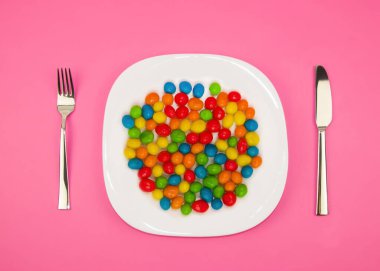 multi-colored chocolate candy lie on a plate