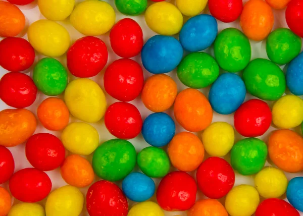background from multi-colored candy dragees close up