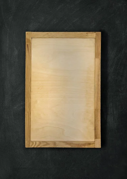 empty plywood frame on a dark background.Top view