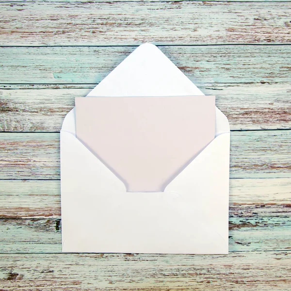 Mock up. Blank envelope on a wooden background and Top view.