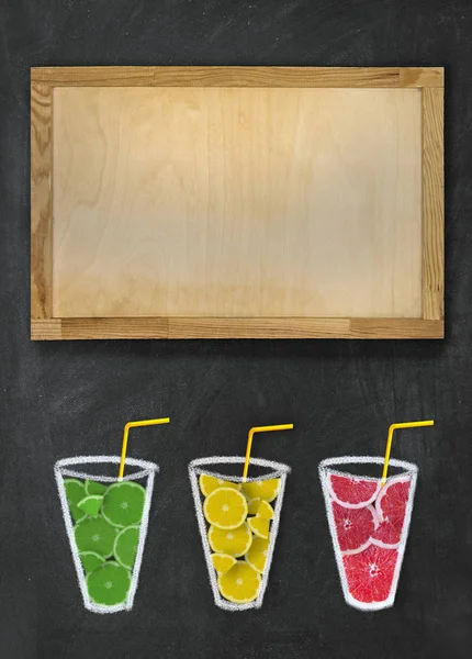 Slices of fruit in a glass and a wooden board. Citrus smoothie.