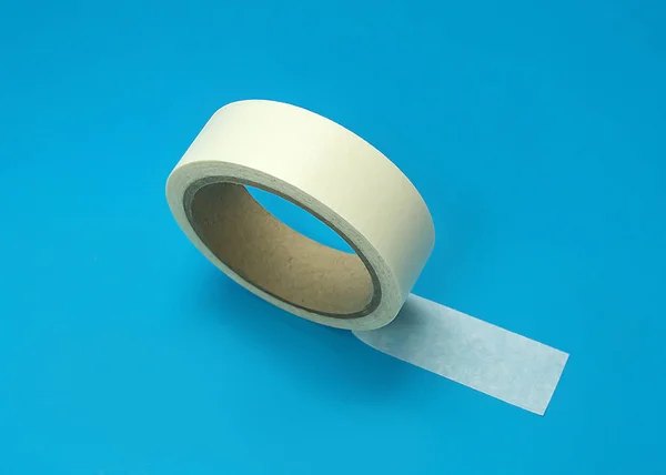 Round roll of white duct tape, adhesive tape