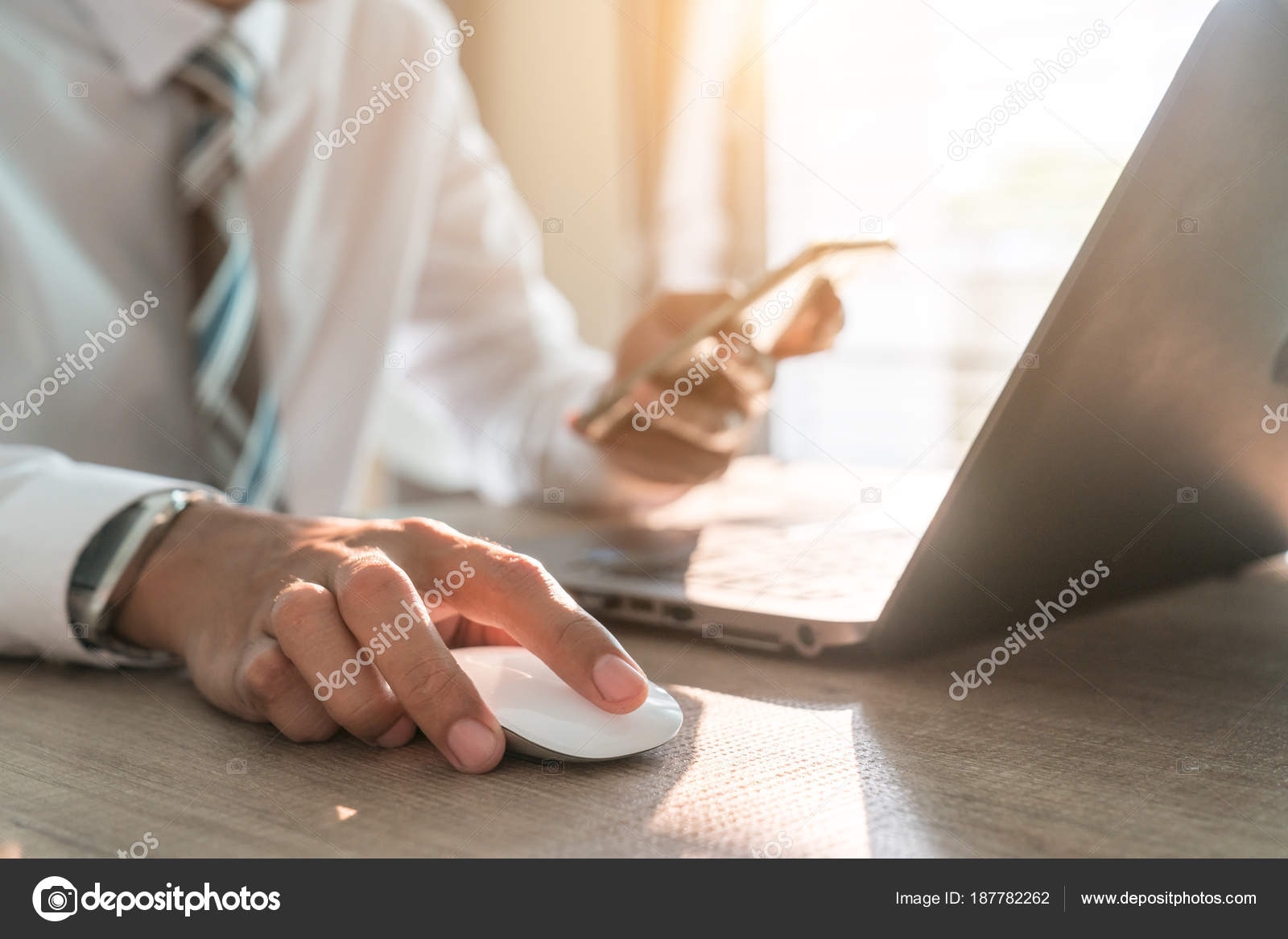 Male Hand Holding Computer Mouse With Laptop Keyboard In The Bac