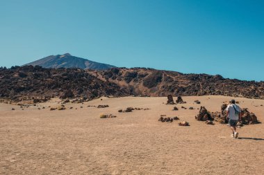 Man walking on the lonely lunar landscapes 