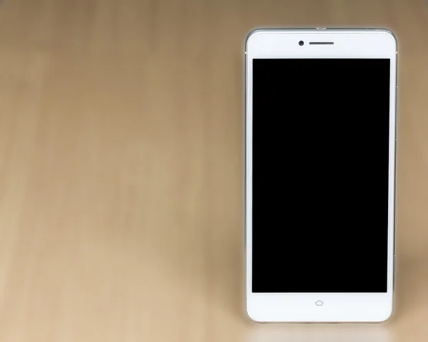 Blank screen white smartphone on desk — Stock Photo, Image