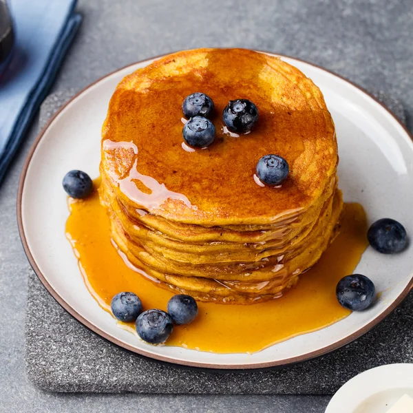 Pumpkin pancakes with maple syrup and blueberries