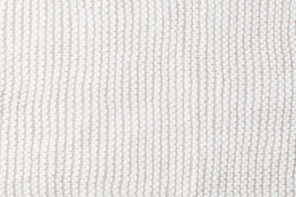 Knitted white scarf pattern background. Top view. Copy space.