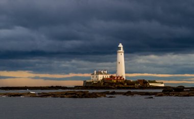 St Mary's Lighthouse as a storm draws nearer at sunrise