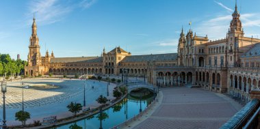 A panorama just after sunrise of the Plaza de Espaa (translated to Spain Square) which is found in the Parque de Maria Luisa in Seville, Andalucia in Southern Spain.