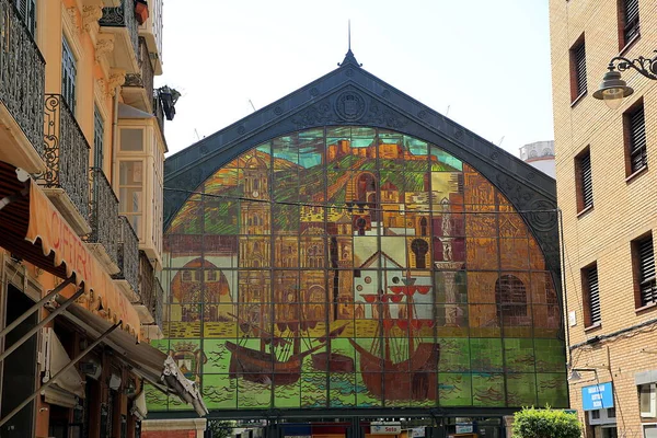 The ornate stained-glass windows of the exterior of the food market in Malaga, Spain
