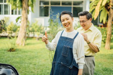 Parkta sonbaharda yaşlı ve güzel bir Asyalı çift. Yaşlı bir çiftin parkta dinlenirken çekilmiş bir portresi..