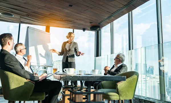 Meeting and discussion concept.business people communicating in office.Mature businessman discuss information with a colleague in a modern business lounge high up in an office tower.