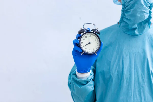 Male surgeon medical specialist with clock.