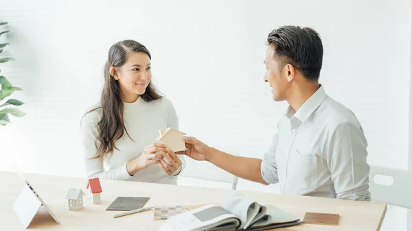 The best choice of house.House owner and architect discussing a choice.Couple dreaming of new home.