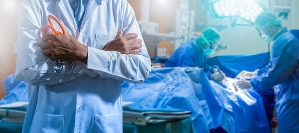 Smiling professional doctor and medical staff working at the hospital.Double exposure Several surgeons surrounding patient on operating table during their work.