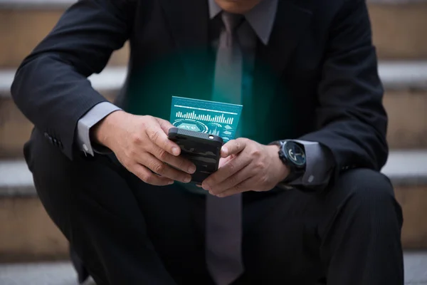 Future, technology, business and people concept - close up of male hand with smartphone and hologram of graph.