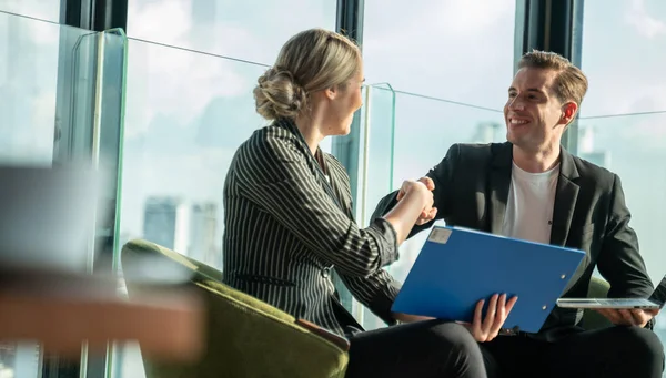 Meeting and discussion concept.business people communicating in office.Mature businessman discuss information with a colleague in a modern business lounge high up in an office tower.