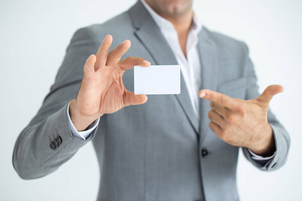 Businessman's hand showing business card - close up shot on white background.