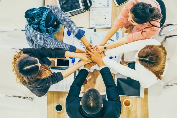 Beautiful Business People Join Hand Together. Cross Processing of Smart People Indoors. Team Work Concept. Successful Business People Teamwork Collaboration Relation Concept. Top View.Happy business colleagues in modern office.