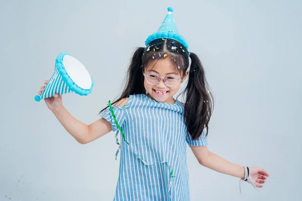 kids jumping in a room with decorative tape on the wall.