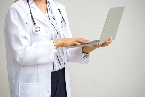 Doctor working with computer notebook.Female doctor with stethoscope working with computer on white background.