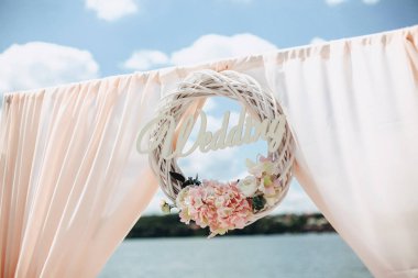 Düğün töreni güneşli bir pembe tonlarında bir göl kıyısında