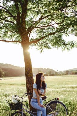 Kız ile bir köpek yavrusu bir bisiklet arka alanına yürüyor 