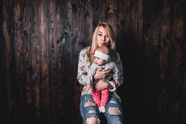 stock image mother with her baby in a bar chair against the background of a 