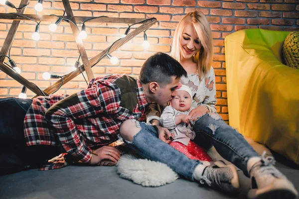 Eltern mit ihrem Kind auf dem Hintergrund eines Sterns mit Glühbirnen — Stockfoto