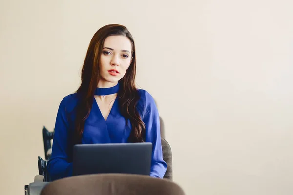 girl in auditorium works with laptop