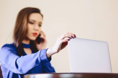 iş kadını dizüstü bilgisayarda ofis ve çalışma telefonla konuşuyor